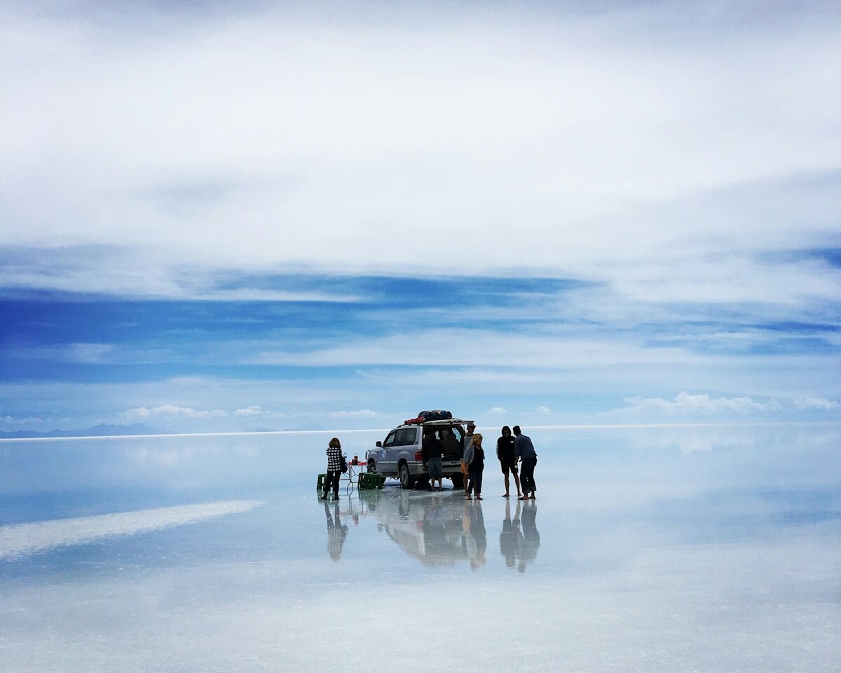 people standing near silver SUV