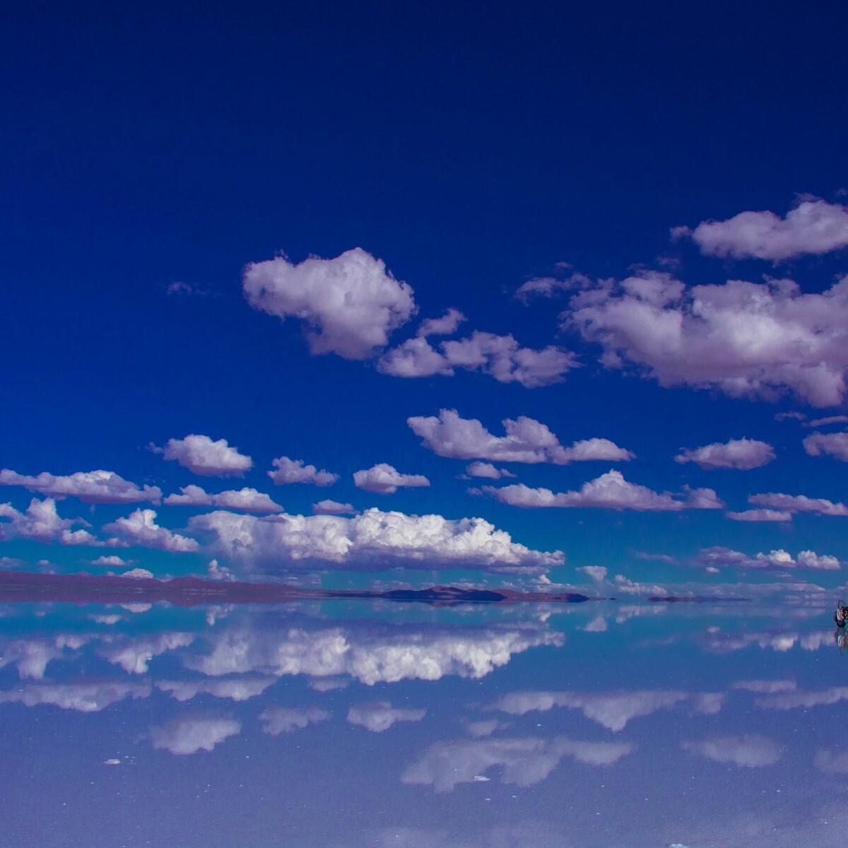 blue sky and white clouds over calm sea