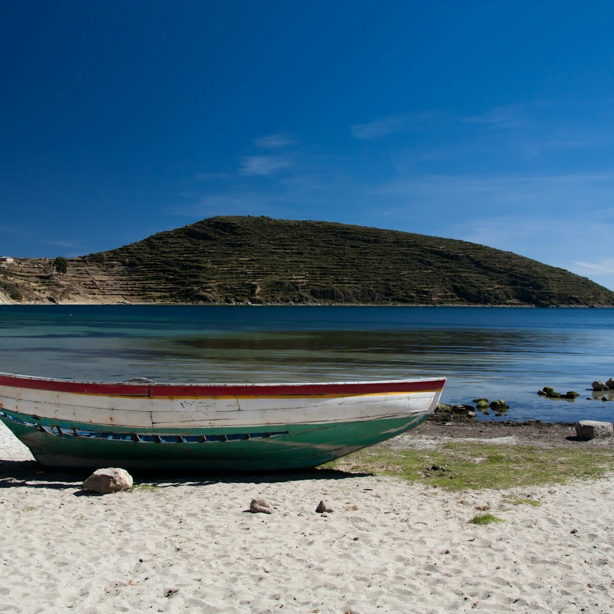 white and green boat near body of water