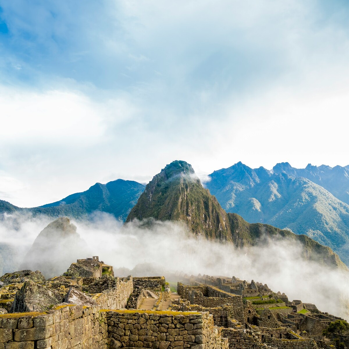 photo of ruins beside wall covering fogs
