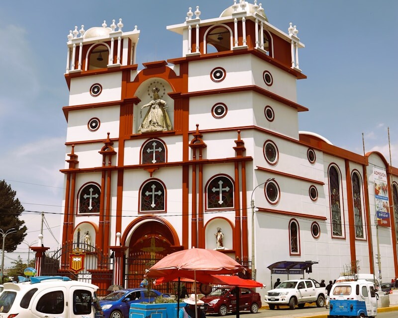 a large white and red building with a clock on it's side