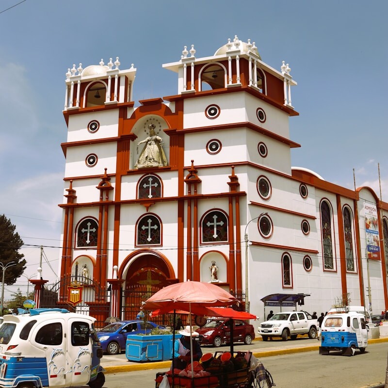 a large white and red building with a clock on it's side
