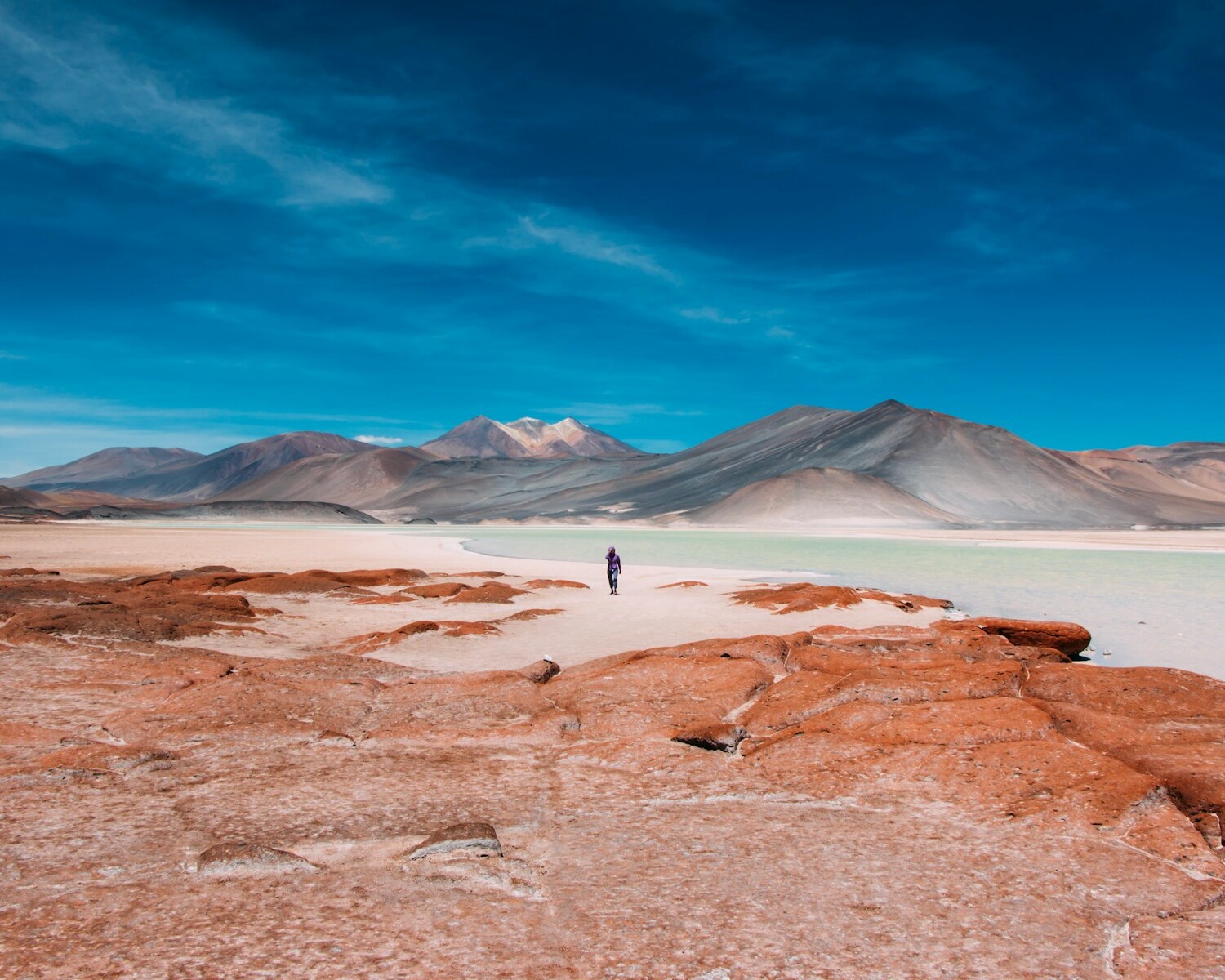 person walking in distance of mountain