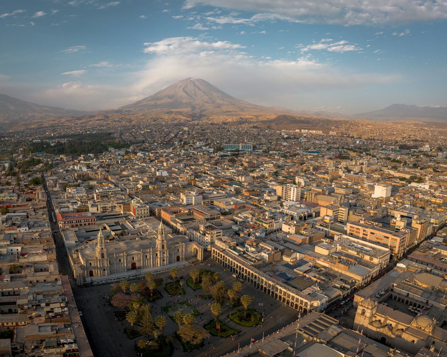 A panoramic view of a city with a mountain in the background