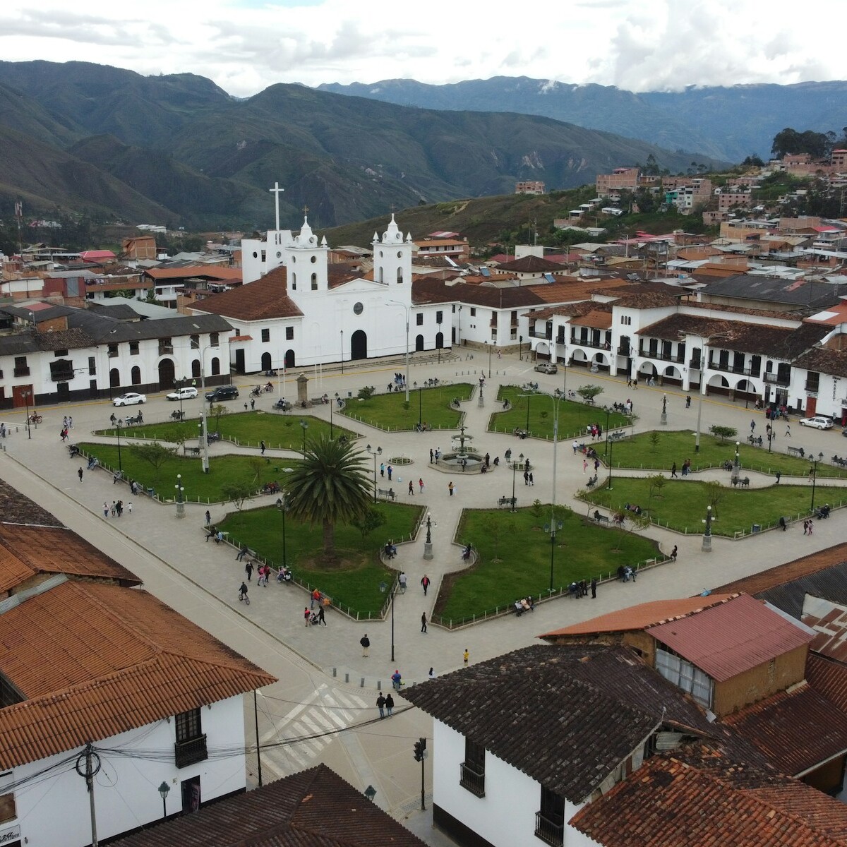 an aerial view of a city with a church in the center
