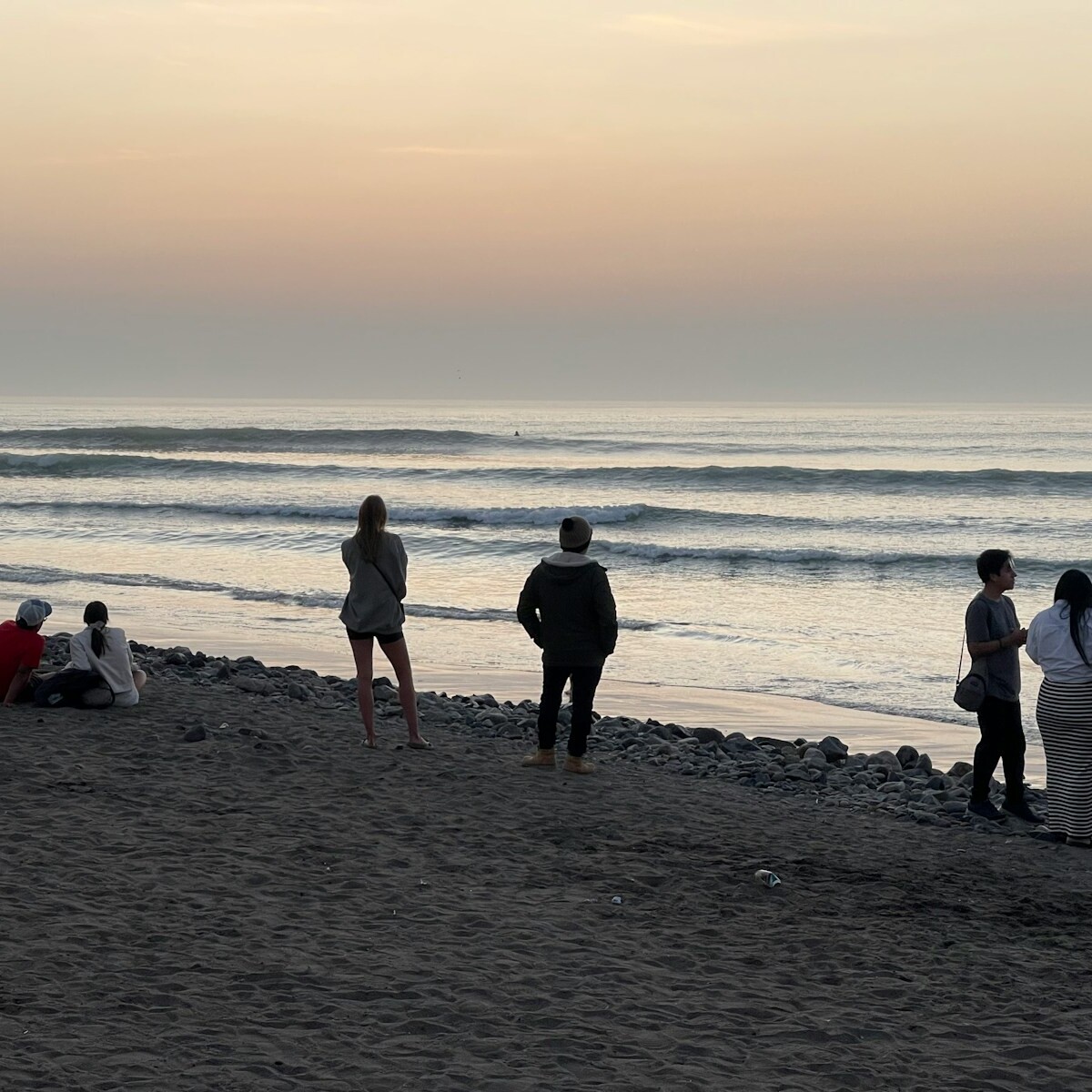 A group of people standing on top of a beach