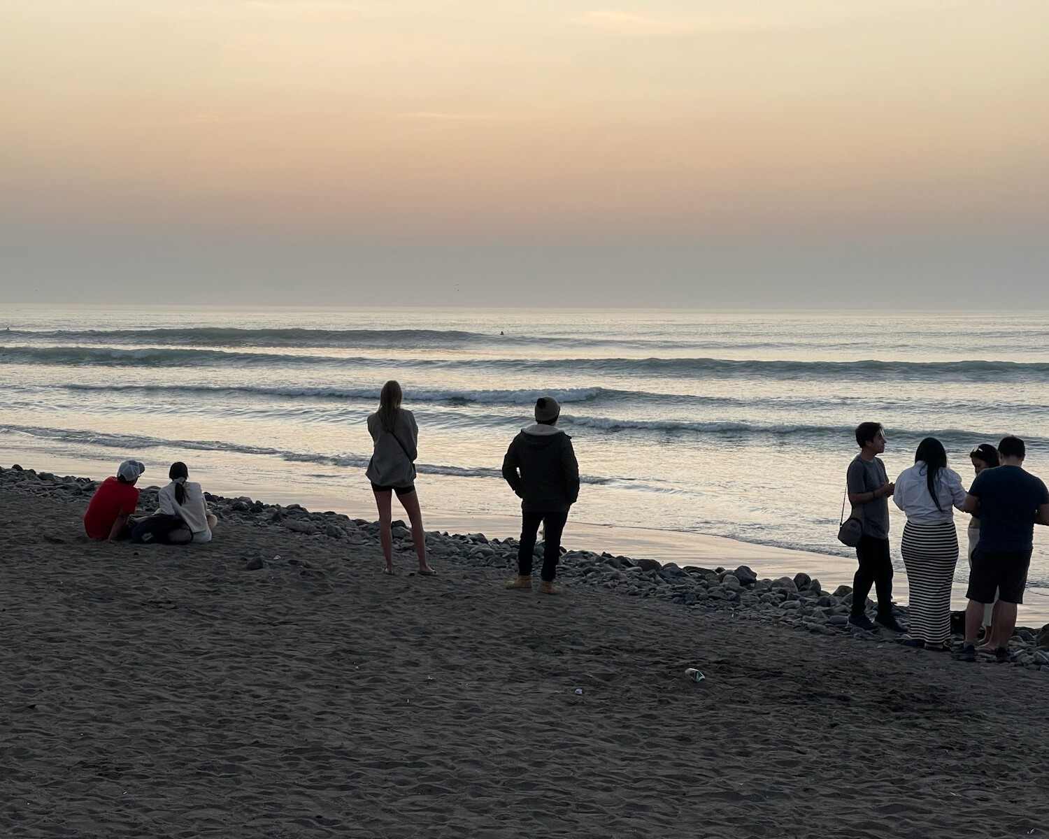 A group of people standing on top of a beach