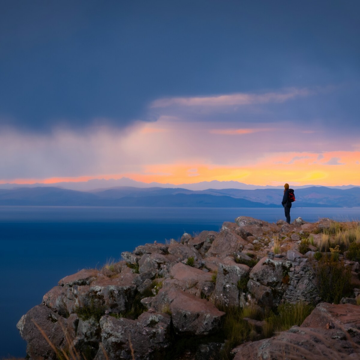 a person standing on top of a rocky cliff