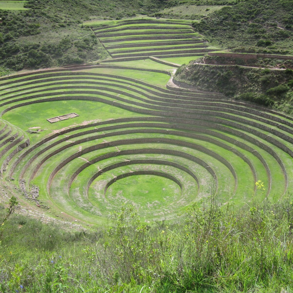 A large circular structure in the middle of a field